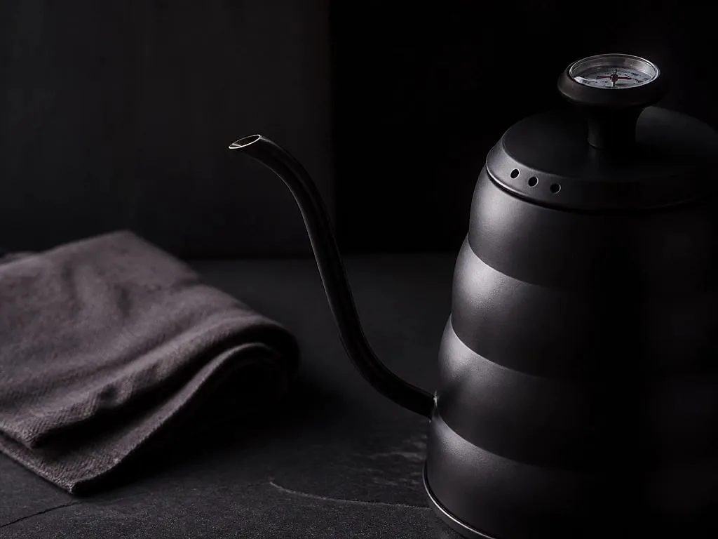 Close still life of brewing tools on a dark surface